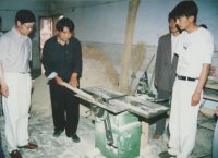 A student tries his hand at the circular saw while others look on. Duan Zhaobing took these photos, so he does not appear.