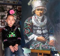 Miao child posing with a photo of a traditional Miao costume