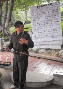 Er hu player in front of music in Chinese notation, West Lake Park, Fuzhou in Fujian province