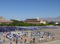 All the students and staff (group in the foreground) do morning exercises.  Copyright: Jane Furkert