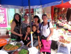 Rosy Look, Emily, Marcia, Rapanui + Takatia with Chinese teacher at market, Bazhong