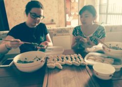 Learning to make dumplings with her host mother