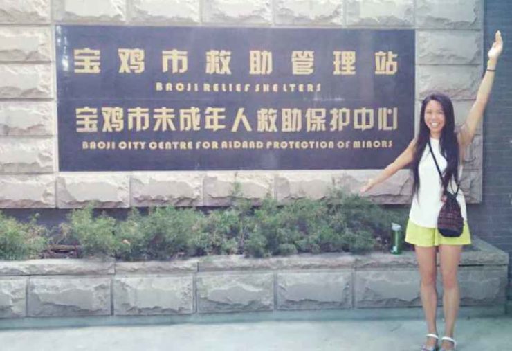 Joanne Chan at the entrance of Baoji City Centre for Aid and Protection of Minors [not to be confused with the NGL "Xinxing Aid for Street Kids"...