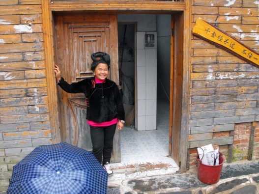 Toilet attendant at toilets in Datong Miao village.