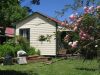 Rewi Alley Whare after maintenance, with Rose Blossom