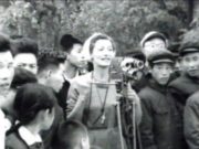 Group of people around a woman with a camera