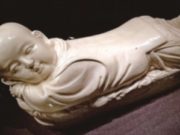 sculpture of a baby with a flattened area on the back