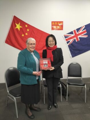 President Barbara Markland presenting a copy of the book on Appo Hocton to the Consul General
