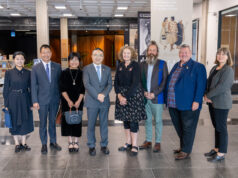 Attendees at a special viewing of items from the Alexander Turnbull Library, Wellington. China Ambassador Dr Wang Xialong and National Librarian Rachel Essen are in the centre, with Dr Alistair Shaw standing next to the National Librarian.