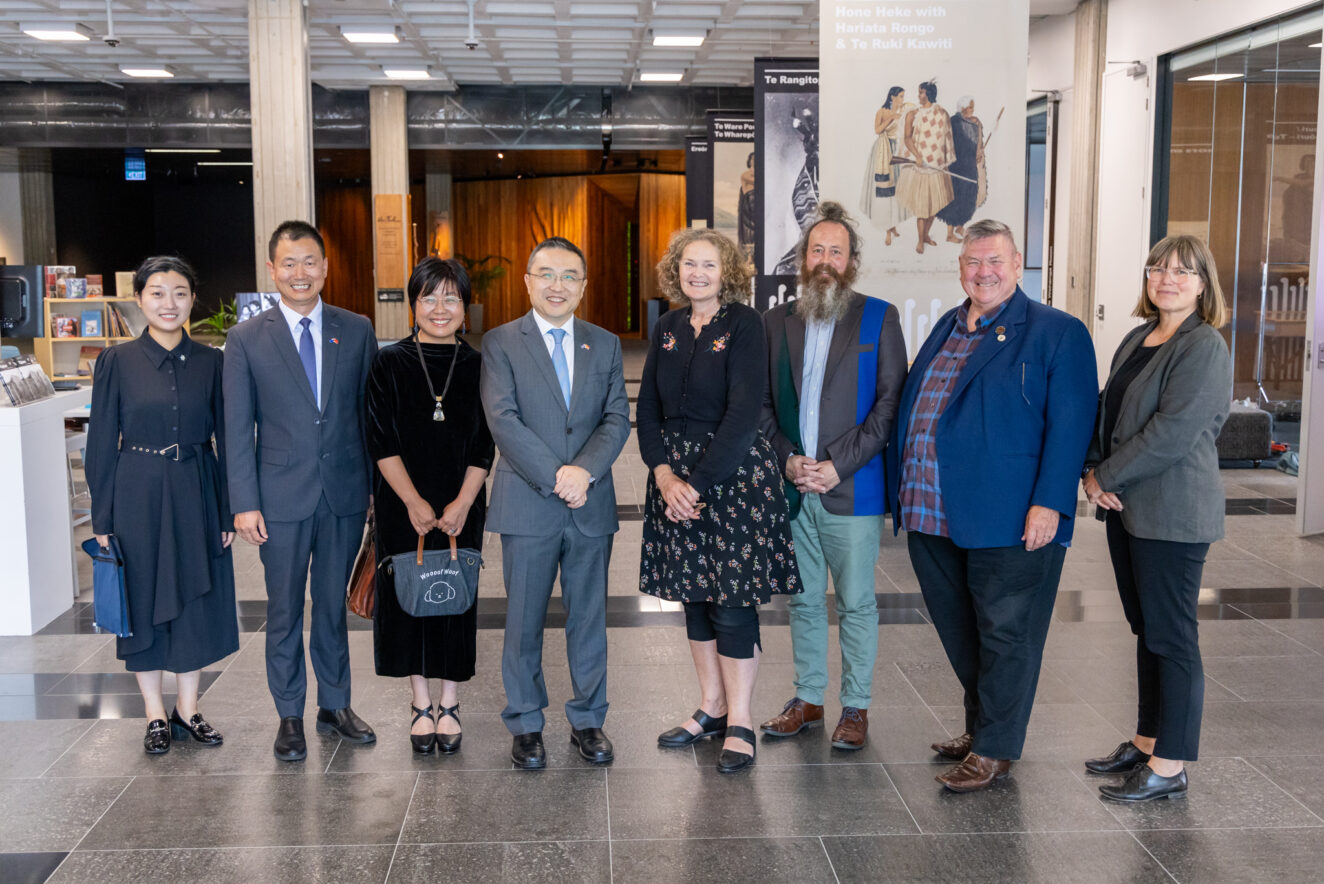 Attendees at a special viewing of items from the Alexander Turnbull Library, Wellington. China Ambassador Dr Wang Xialong and National Librarian Rachel Essen are in the centre, with Dr Alistair Shaw standing next to the National Librarian.